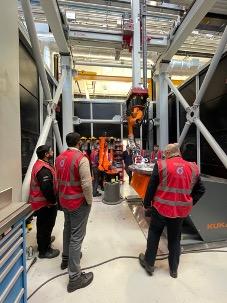 Men in pink high vis jackets in industrial setting