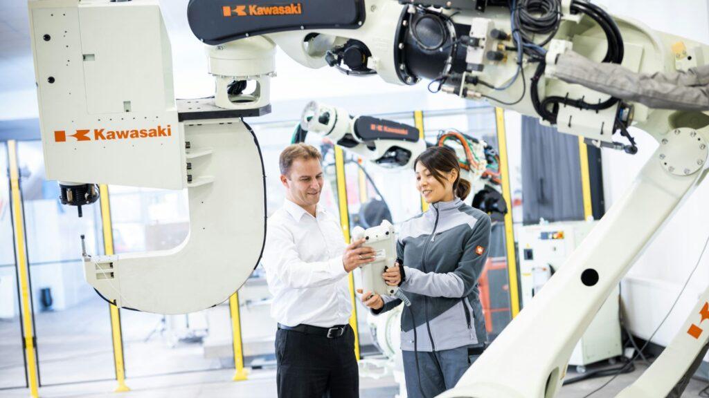 Man and woman next to robots