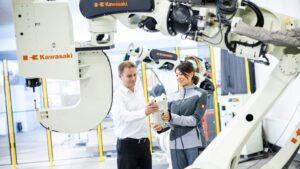 Man and woman next to robots